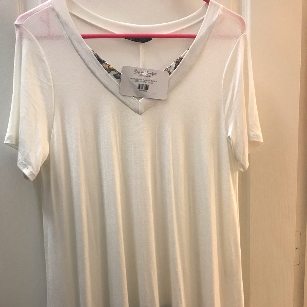 Off white top with floral accent